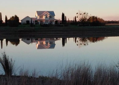 Scenic house reflection near Better Day Massage in Oakey, Queensland, AU at sunset.