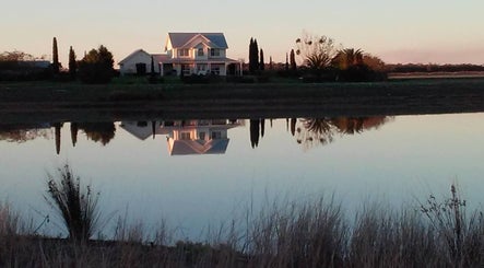 Scenic house reflection near Better Day Massage in Oakey, Queensland, AU at sunset.