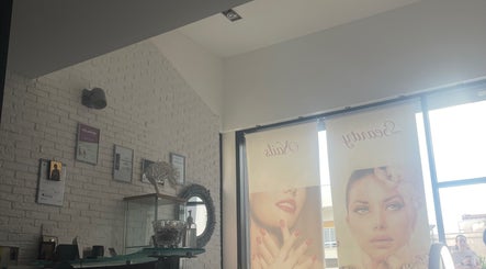 Εσωτερικό του “GLAM” BEAUTY STUDIO στην Πάφος, Πάφος, CY με κομψά διακοσμητικά και αφίσες ομορφιάς.