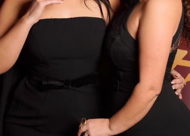 Two women in elegant black dresses at Desada Beauty Lounge, Barking, England, GB.