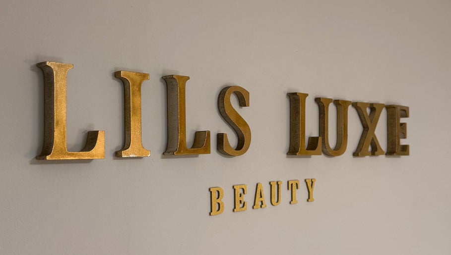 Lilsluxebeauty sign in gold letters on a wall, located on Hewell Lane, England, GB.