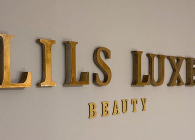 Lilsluxebeauty sign in gold letters on a wall, located on Hewell Lane, England, GB.
