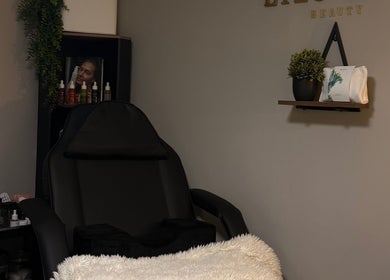 Lilsluxebeauty treatment room at Hewell Lane, England, GB featuring plush chair and calming decor.