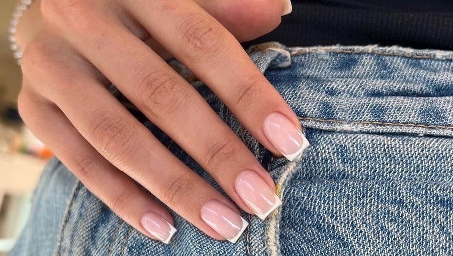 Elegant French tip nails at 24 Nails in Leeds, England, GB, showcasing modern style and precision.
