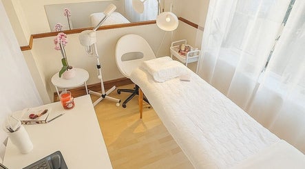 Relaxing treatment room at The Beauty By Nina, Dublin, County Dublin, IE, featuring a white massage table.
