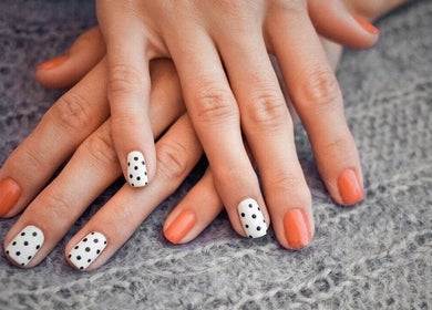 Stylish polka dot and coral nails at Pampered Beauty Room, Cowdenbeath, Scotland, GB.