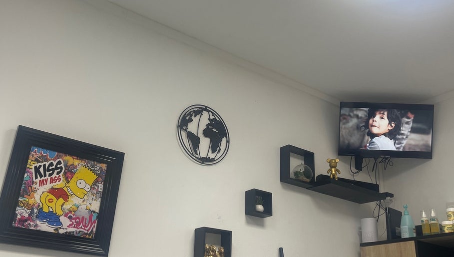 Décor moderne à Universal’s barber, Le Moule, Grande-terre avec affiches et étagères murales.