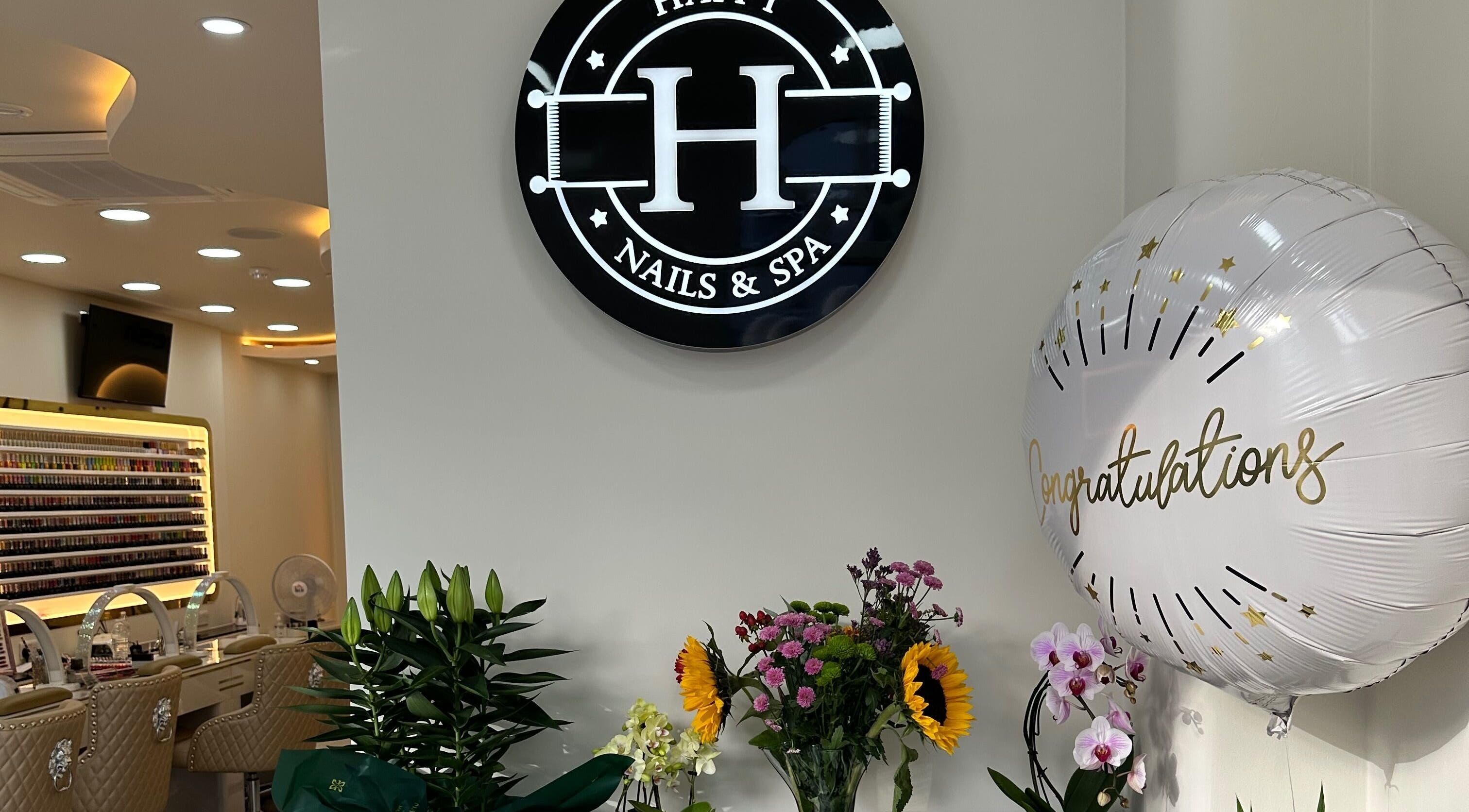 Interior of Happy Nails Doncaster, England, featuring chic seating and vibrant flower arrangements.