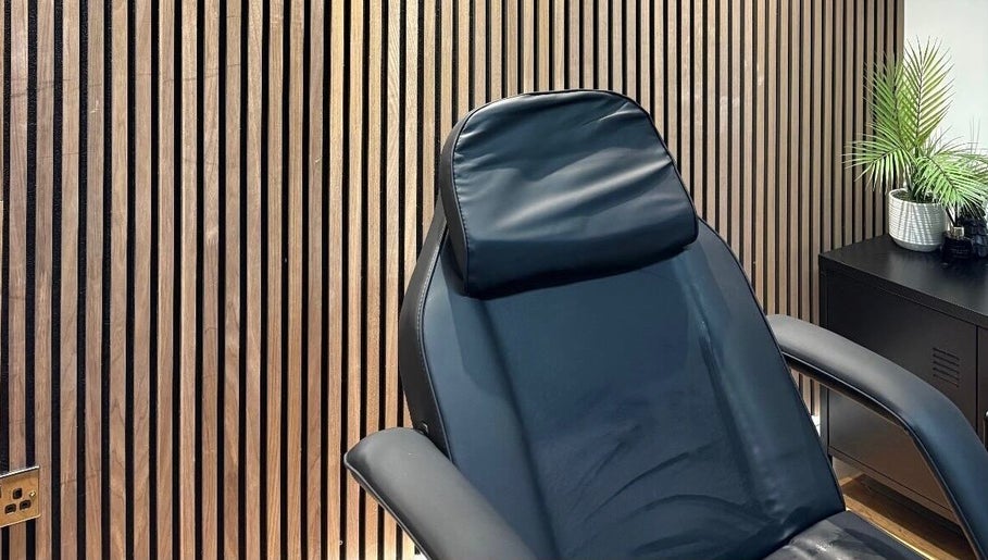 Luxurious treatment chair in Skin Plus, Burgh Le Marsh, England, GB, set against a stylish wooden wall.