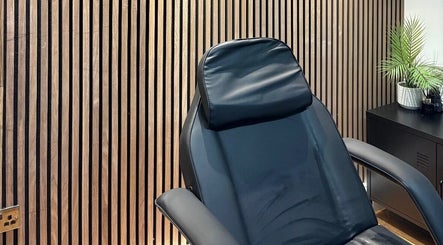 Luxurious treatment chair in Skin Plus, Burgh Le Marsh, England, GB, set against a stylish wooden wall.