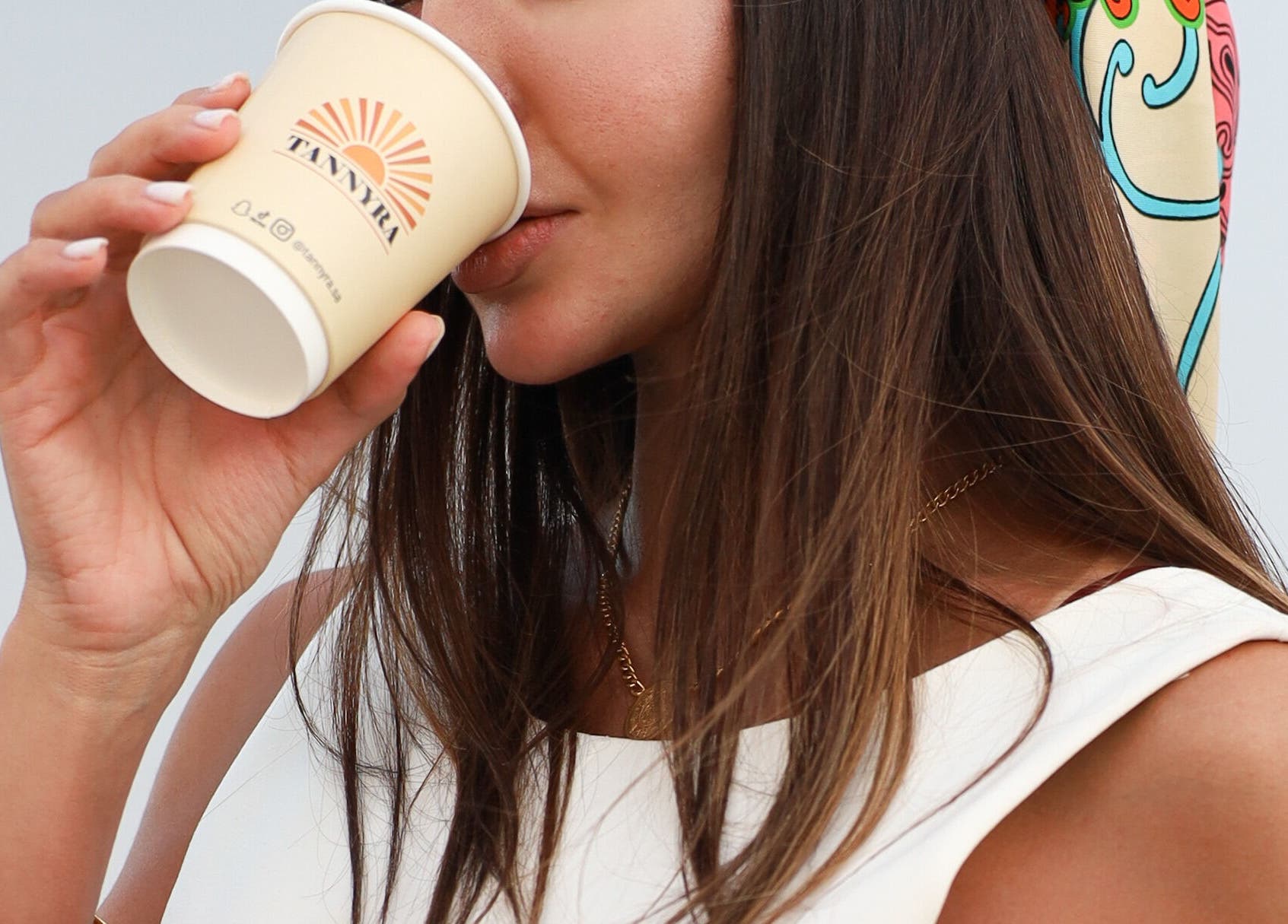 A woman enjoying coffee at Tannyra, Riyadh, Riyadh Province, SA, showcasing relaxation and style.