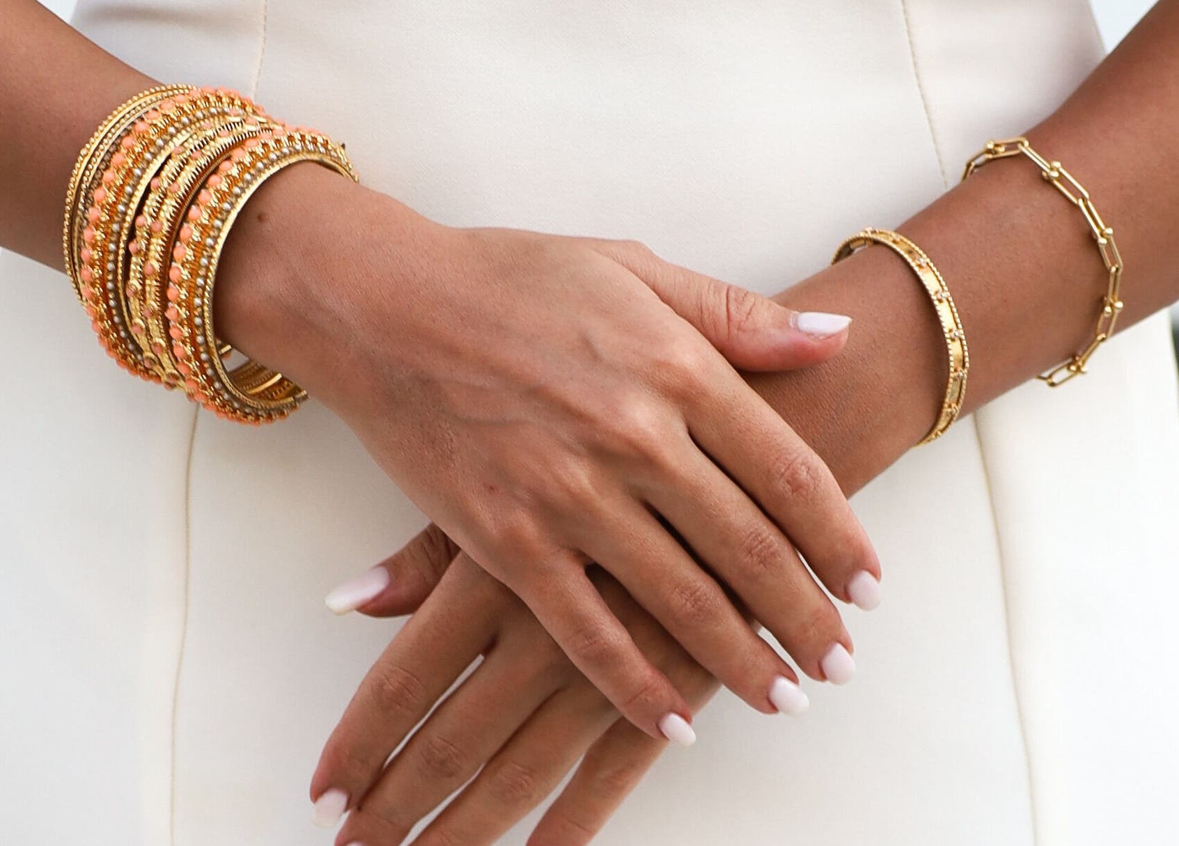 Close-up of elegant gold bracelets on hands at Tannyra, Riyadh, Riyadh Province, SA.