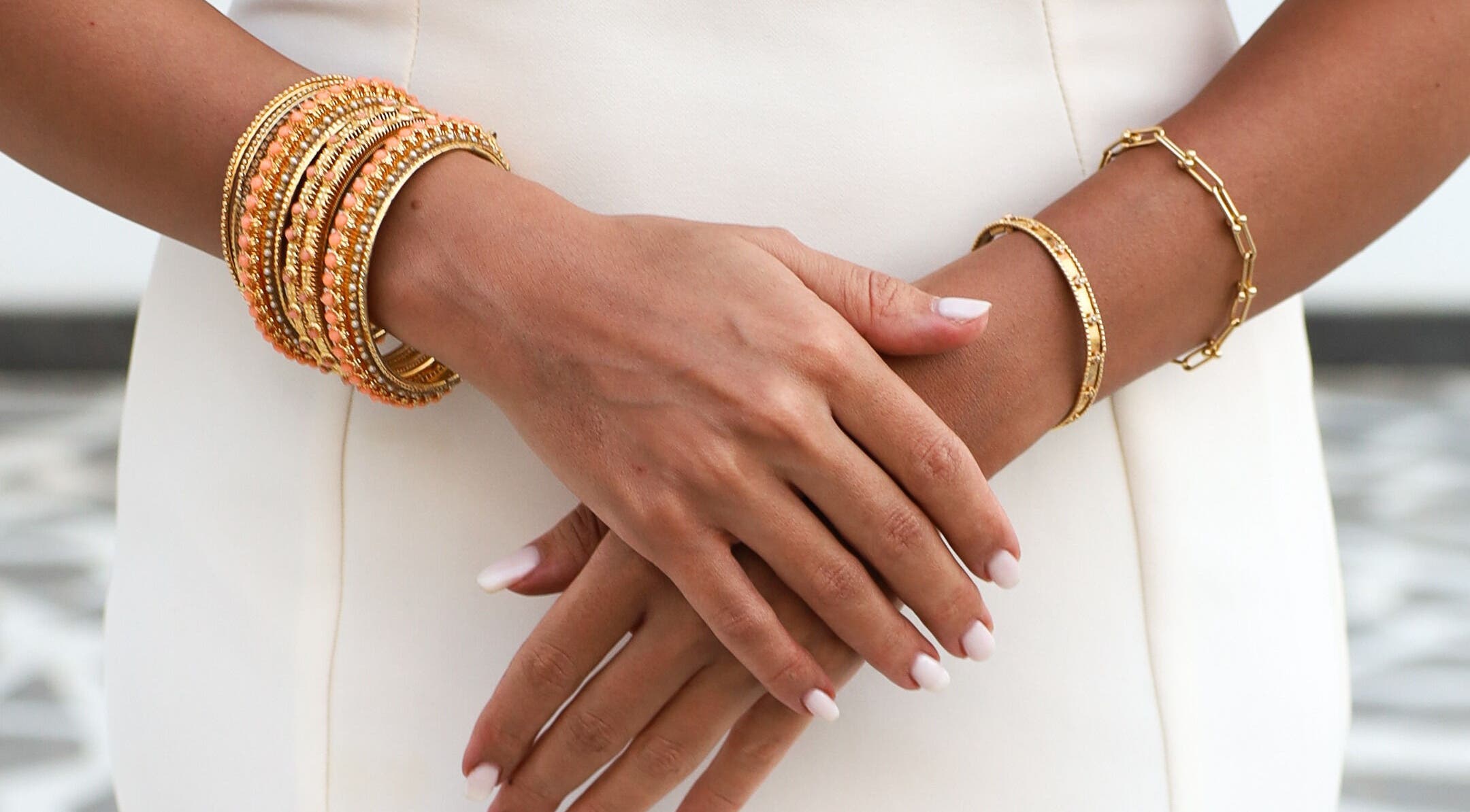 Close-up of elegant gold bracelets on hands at Tannyra, Riyadh, Riyadh Province, SA.