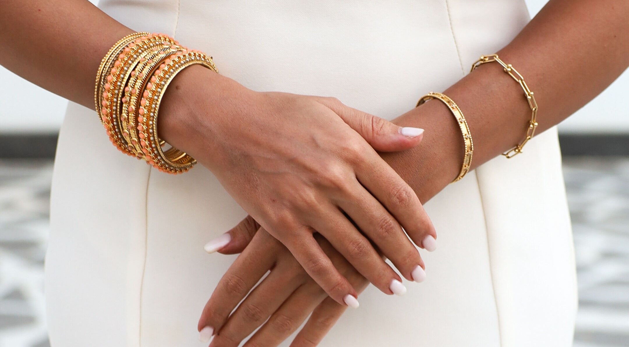 Close-up of elegant gold bracelets on hands at Tannyra, Riyadh, Riyadh Province, SA.