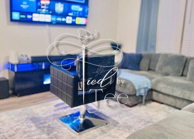 Comfortable salon chair in Tied By Tee, Macon, Georgia, US, set against a modern, cozy living area.