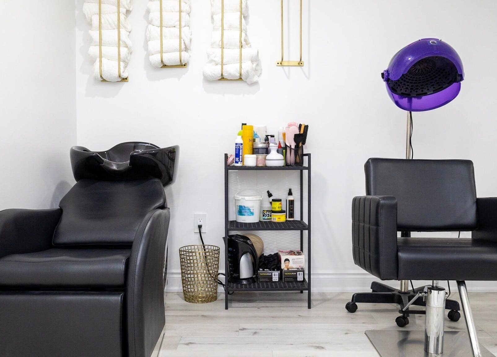 Modern salon chair and sink at BeyondBeautyHamilton, Hamilton, Ontario, CA, showcasing stylish interior.