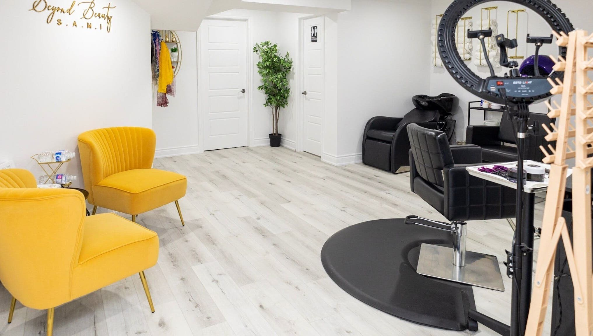 Bright interior of BeyondBeautyHamilton salon in Hamilton, Ontario, CA with stylish seating and hair stations.