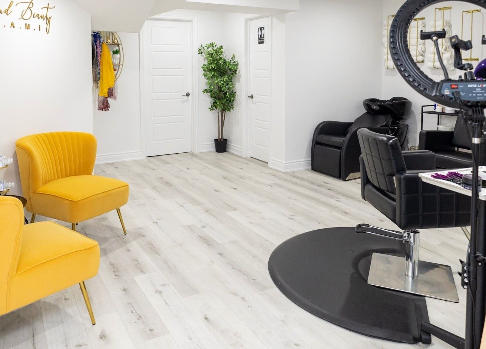 Bright interior of BeyondBeautyHamilton salon in Hamilton, Ontario, CA with stylish seating and hair stations.