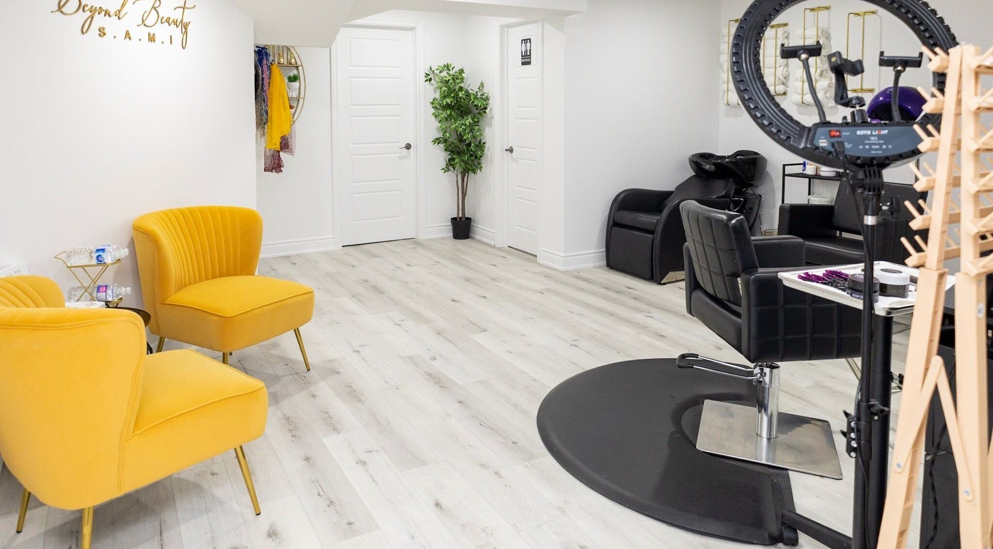 Bright interior of BeyondBeautyHamilton salon in Hamilton, Ontario, CA with stylish seating and hair stations.