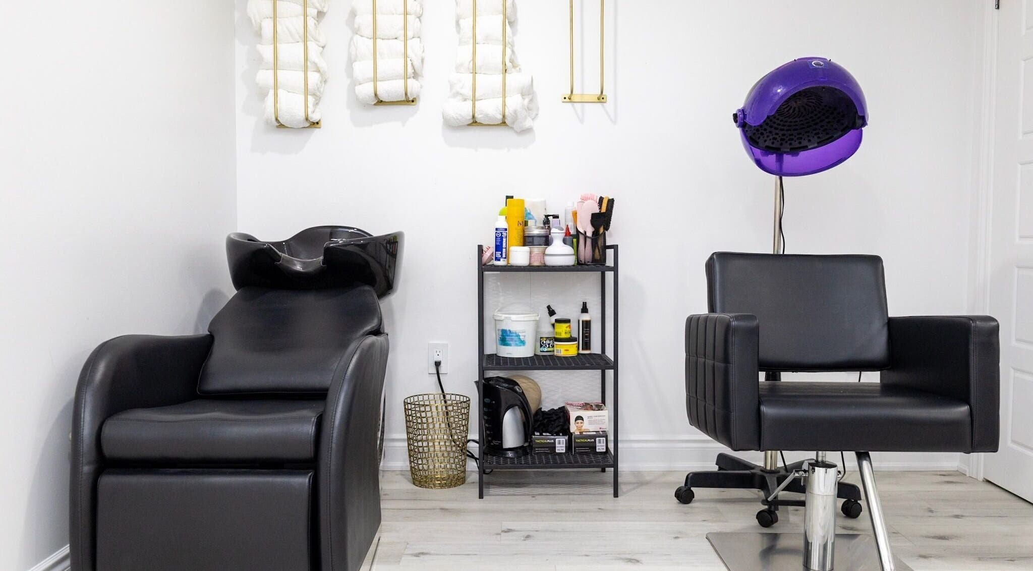 Modern salon station at BeyondBeautyHamilton in Hamilton, Ontario, CA featuring chair and hair washing area.