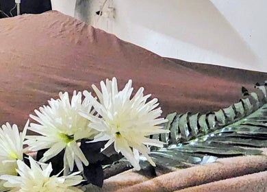 Peaceful spa bed at MbeautySpa, Willemstad, Curaçao, CW adorned with elegant white flowers.