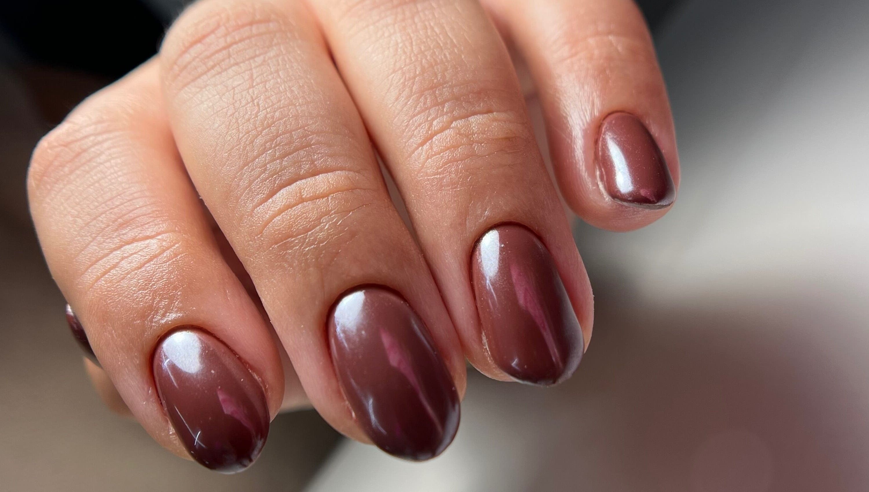 Close-up of glossy brown nails at Luxe Nails & Studio, San Juan, San Juan, PR.