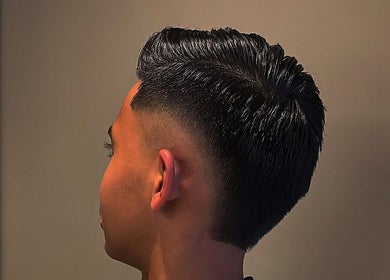 Chic fade haircut at Bilscutz, Singapore, showcasing modern style and skill.