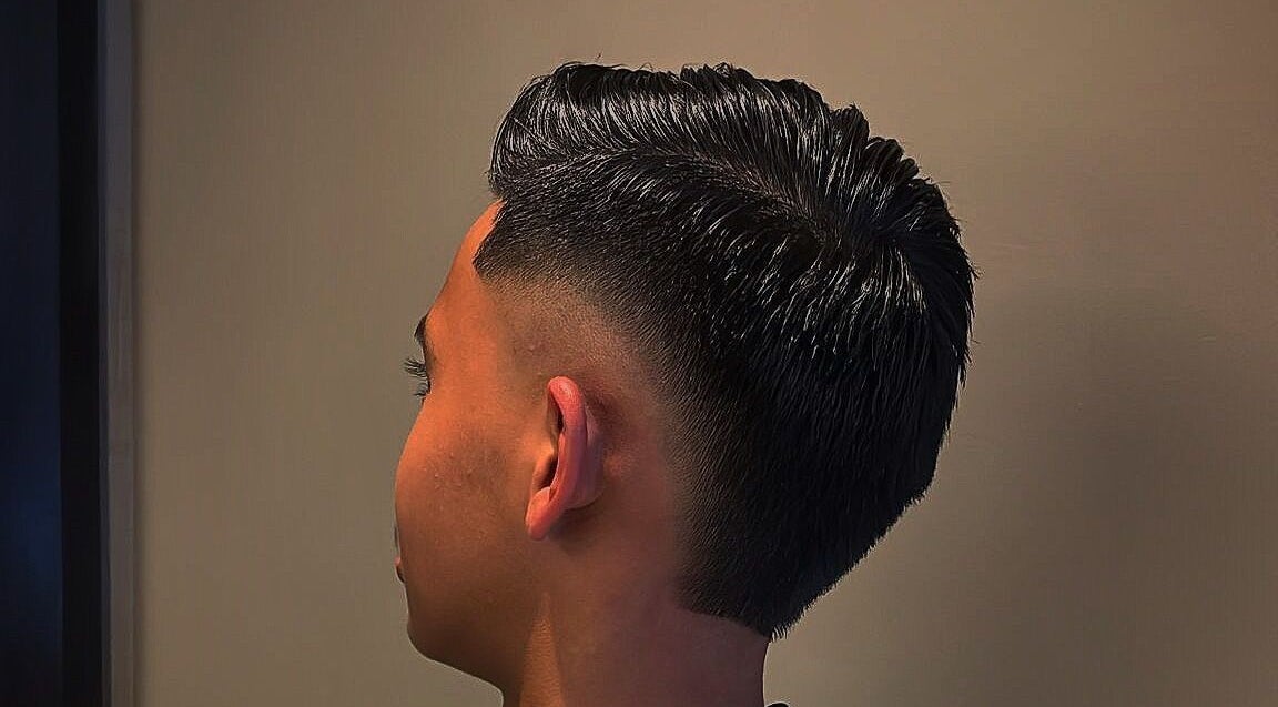 Chic fade haircut at Bilscutz, Singapore, showcasing modern style and skill.