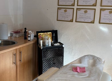 Elegant treatment room at KK Aesthetic, Braintree, England, GB, featuring skincare essentials and certifications.