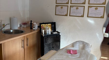 Elegant treatment room at KK Aesthetic, Braintree, England, GB, featuring skincare essentials and certifications.