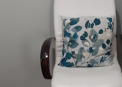 Elegant white chair with floral cushion at Luscious Nails, Cape Town, Western Cape, ZA.