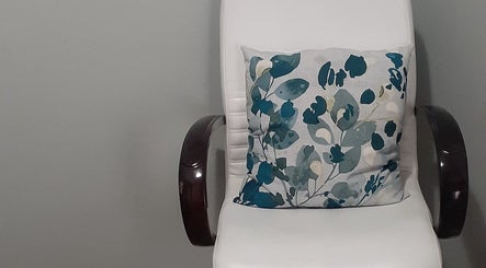 Elegant white chair with floral cushion at Luscious Nails, Cape Town, Western Cape, ZA.