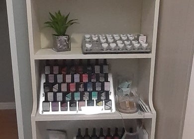 Nail polish display at Luscious Nails, Cape Town, Western Cape, ZA. Vibrant colors neatly arranged on a shelf.