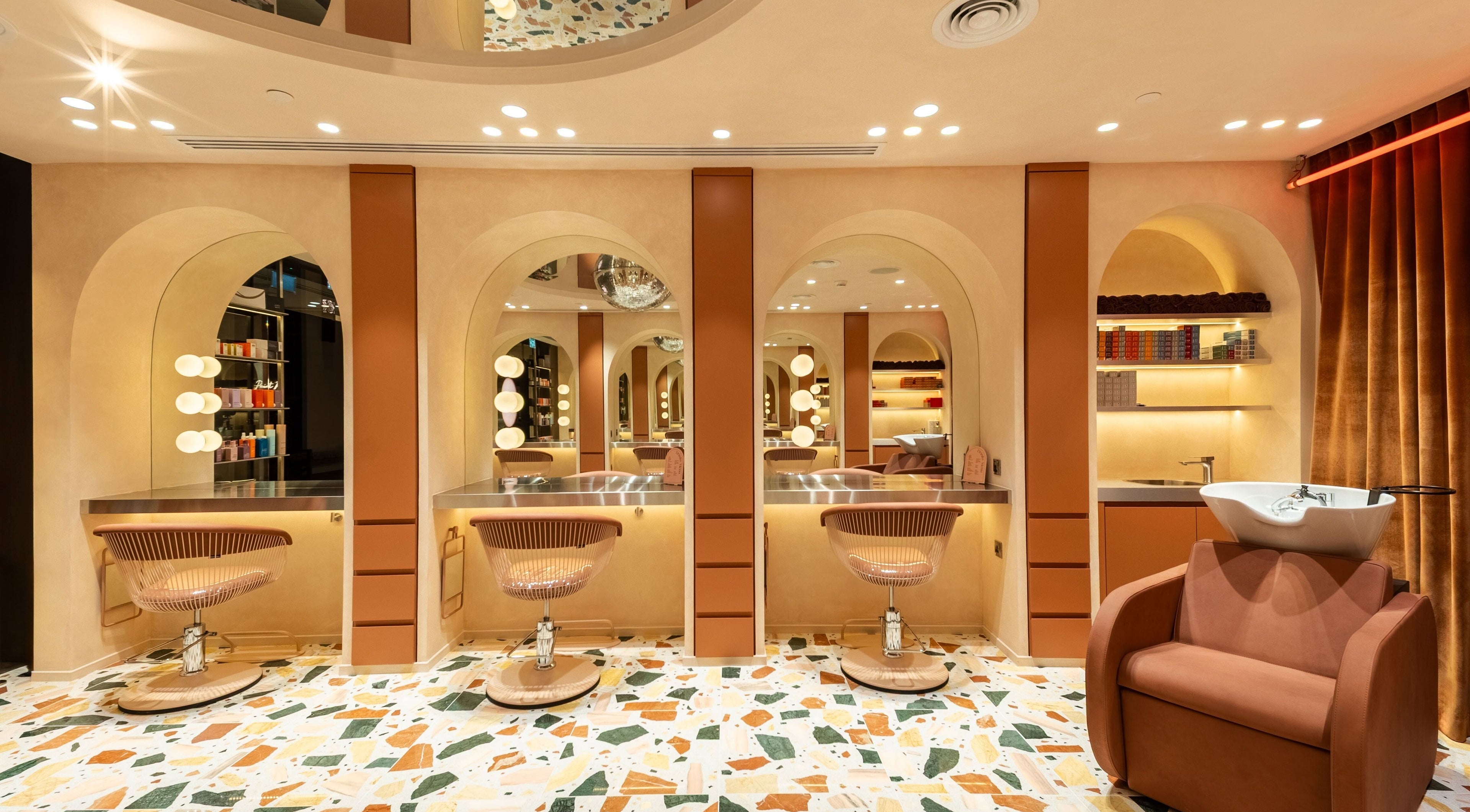 Luxurious salon interior at Beauty Club London in دبي, دبي, AE featuring modern styling stations.