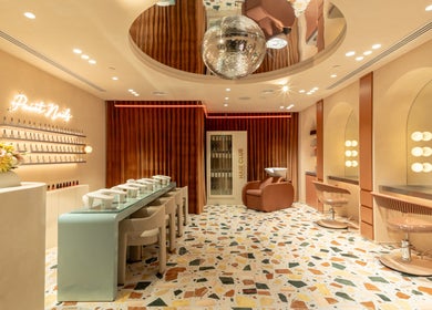 Elegant interior of Beauty Club London in دبي, دبي, AE, featuring vibrant decor and modern salon seating.