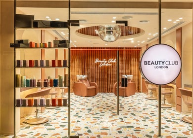 Chic interior of Beauty Club London in دبي, دبي, AE, showcasing luxurious seating and product displays.