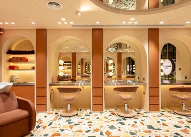 Luxurious salon interior of Beauty Club London, Dubai, AE featuring plush chairs and stylish decor.