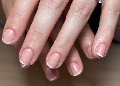 Elegant French manicure at The Nail Room Co., Birmingham, England, GB. Perfectly polished nails with a classic touch.