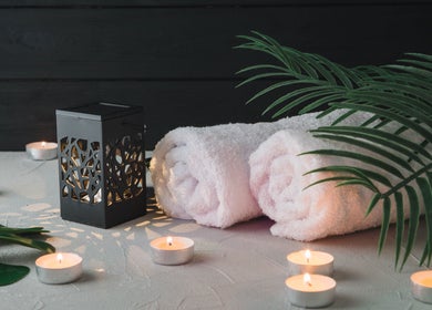 Relaxing spa setting with towels, candles at Mmmassage, Hastings, England, GB.