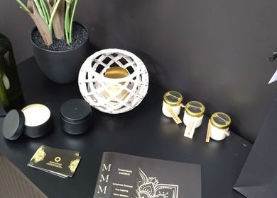 Mmmassage beauty display with candles and oils, Hastings, England, GB. Elegant black and gold decor.