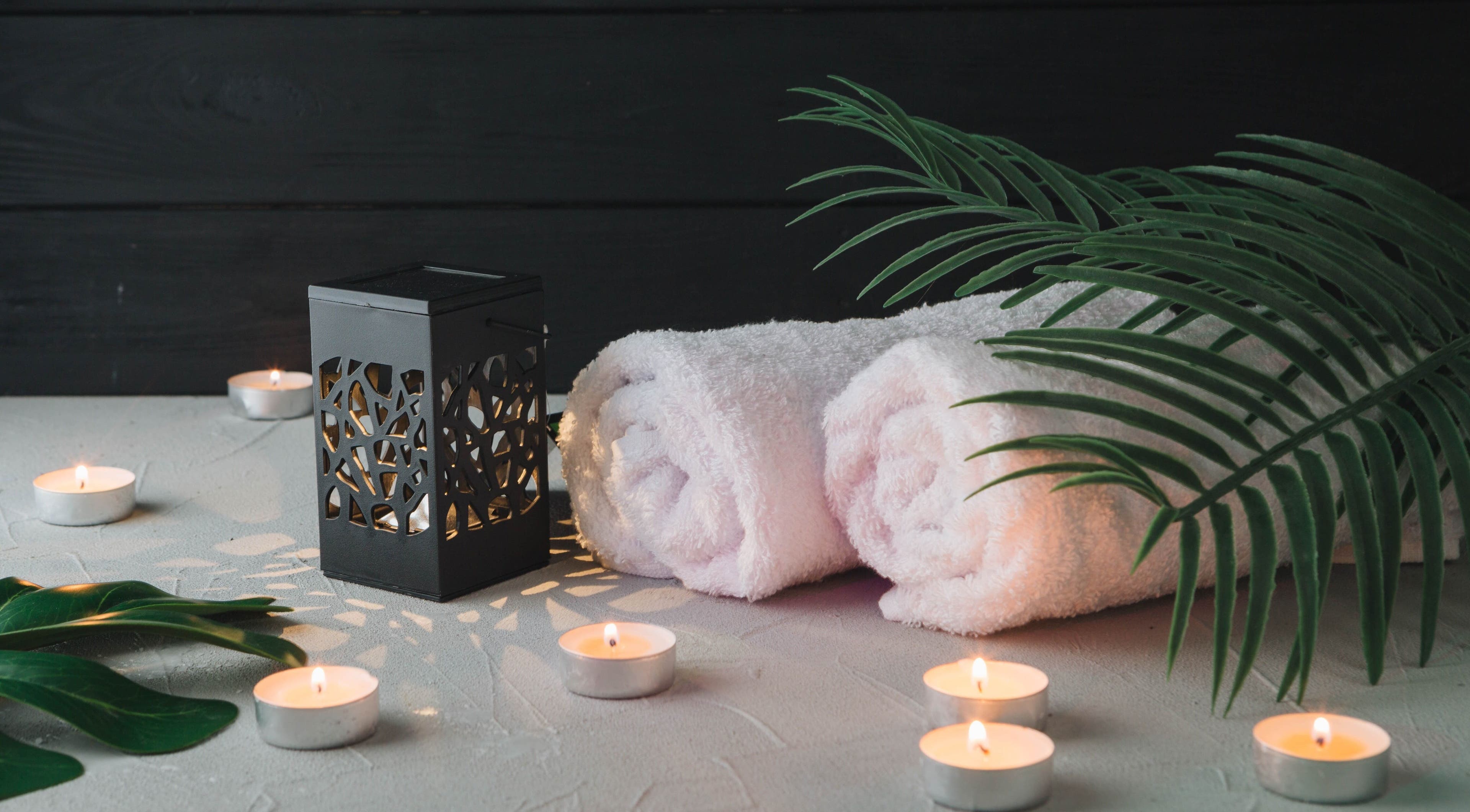 Relaxing spa setup with candles and towels at Mmmassage, Hastings, England, GB.