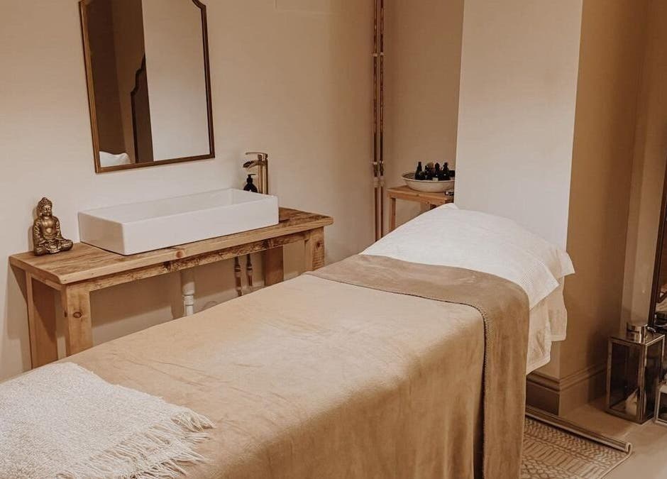 Massage room at Qui Yoga & Ayurveda - Exeter, featuring a cozy treatment table and serene decor, Exeter, England, GB.