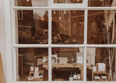 Charming window display at Qui Yoga & Ayurveda - Exeter, showcasing wellness items in Exeter, England, GB.