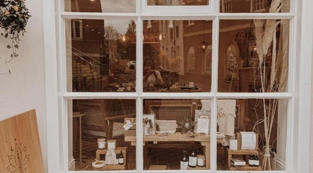 Charming window display at Qui Yoga & Ayurveda - Exeter, showcasing wellness items in Exeter, England, GB.