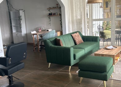 Modern interior of Salon Müller in Grand Baie, Rivière Du Rempart District, MU with green sofa and styling chair.