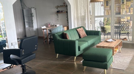 Modern interior of Salon Müller in Grand Baie, Rivière Du Rempart District, MU with green sofa and styling chair.