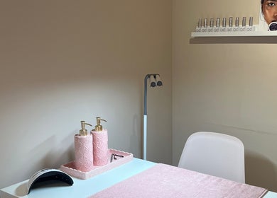 Nail care station at Muse Hair & Beauty, Ossett, England, GB featuring pink decor and modern lighting.