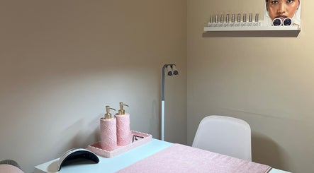 Nail care station at Muse Hair & Beauty, Ossett, England, GB featuring pink decor and modern lighting.