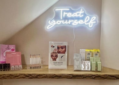 Muse Hair & Beauty display of beauty products under 'Treat yourself' light in Ossett, England, GB.