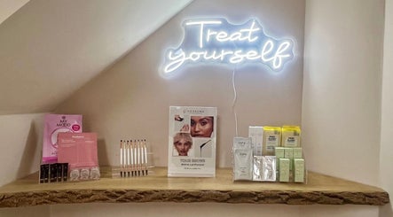 Muse Hair & Beauty display of beauty products under 'Treat yourself' light in Ossett, England, GB.